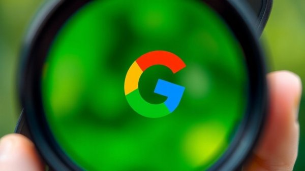 Magnified Google logo on smartphone, deleting a Google account concept.