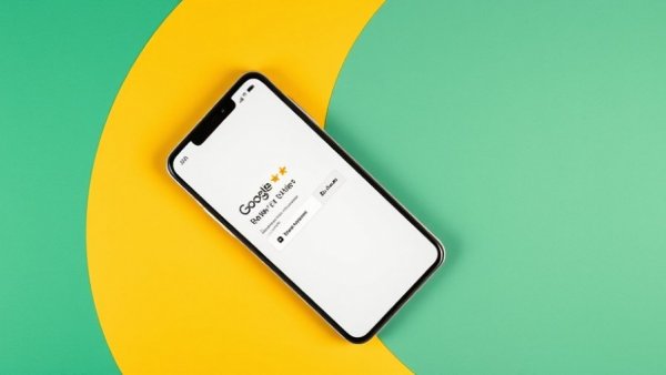 Smartphone with Google review prompt on colorful background related to Google reviews visibility