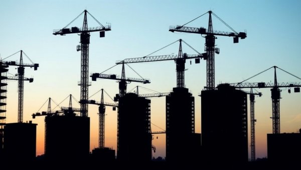 Construction site at twilight for Homes England five-year housing plan.