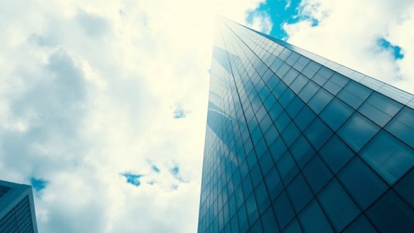 Modern UK hotel sector investment architecture, reflecting blue sky.