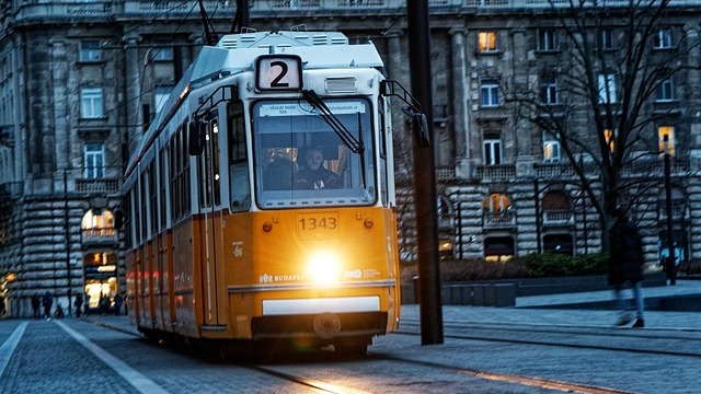 Efficient public transport bus on urban road, aerial view.