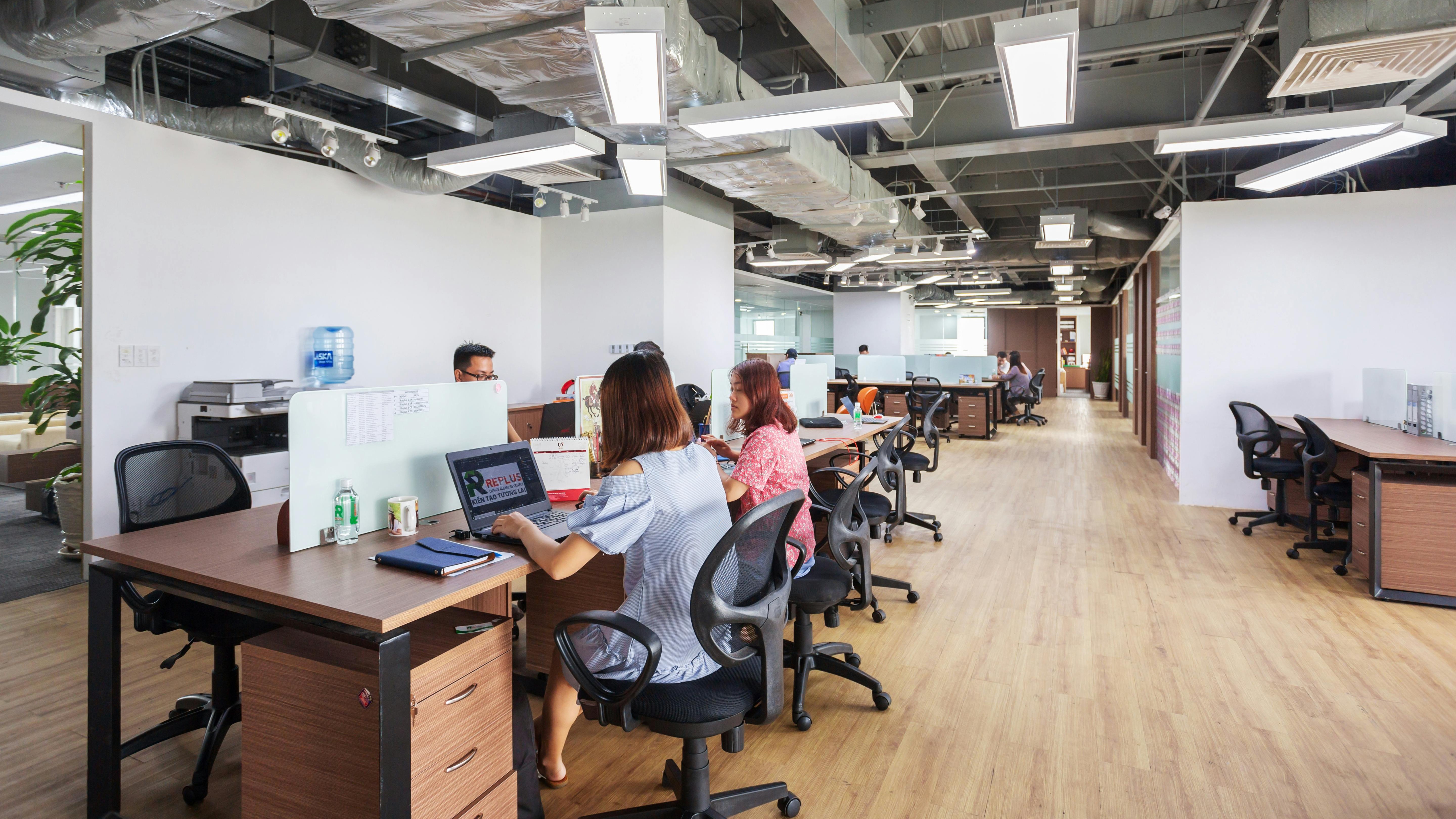 Wide-angle view of a modern, silent office environment with industrial design.