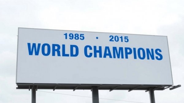 Kansas City billboard showing 'World Champions' from 1985 and 2015 on an overcast day.