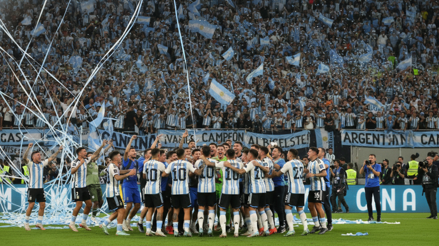 Exuberant crowd in blue and white jerseys celebrating World Cup excitement in Argentina.