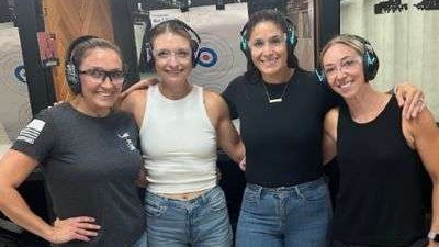 Woman buying guns for self-defense in a gun shop, self-assured.
