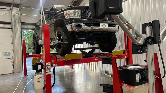 Truck on lift at auto repair Clover SC in detailed shop scene