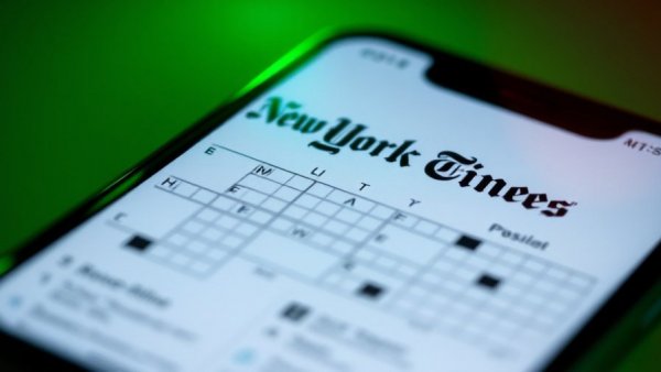 NYT Mini Crossword Answers on smartphone with green background.
