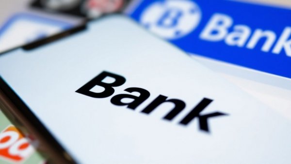 First Citizens Bank logo displayed on smartphone with Silicon Valley Bank in the background, symbolizing business growth.