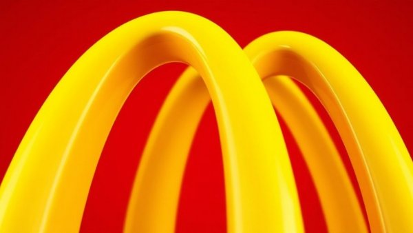 Iconic yellow arches on vibrant red background symbolizing business growth.