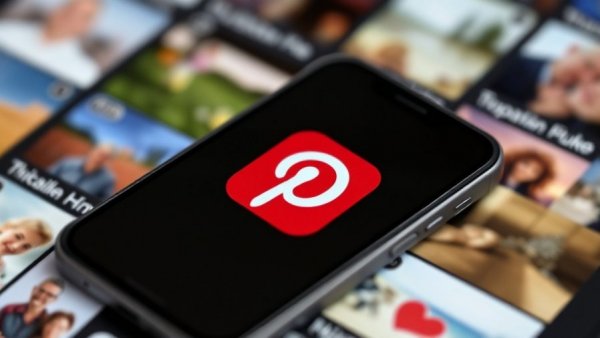 Pinterest app logo on smartphone with image gallery background.