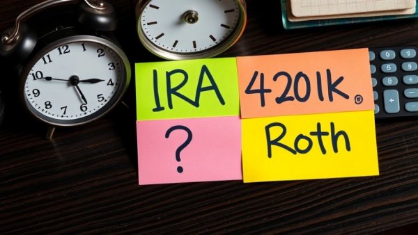IRA contributions for retirees concept with IRA, 401k, and Roth sticky notes.