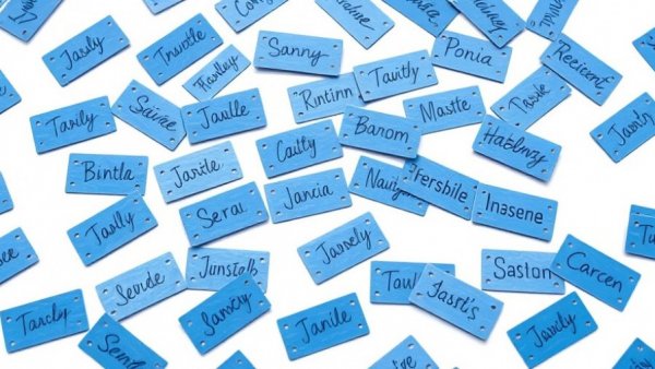 Blue name tags with handwritten brand names for linguistic brand screening.