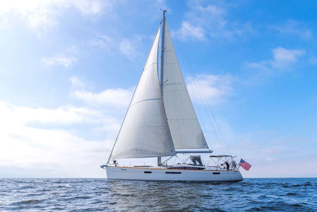 Photorealistic Jeanneau 58 sailing yacht cruising San Diego's blue waters.