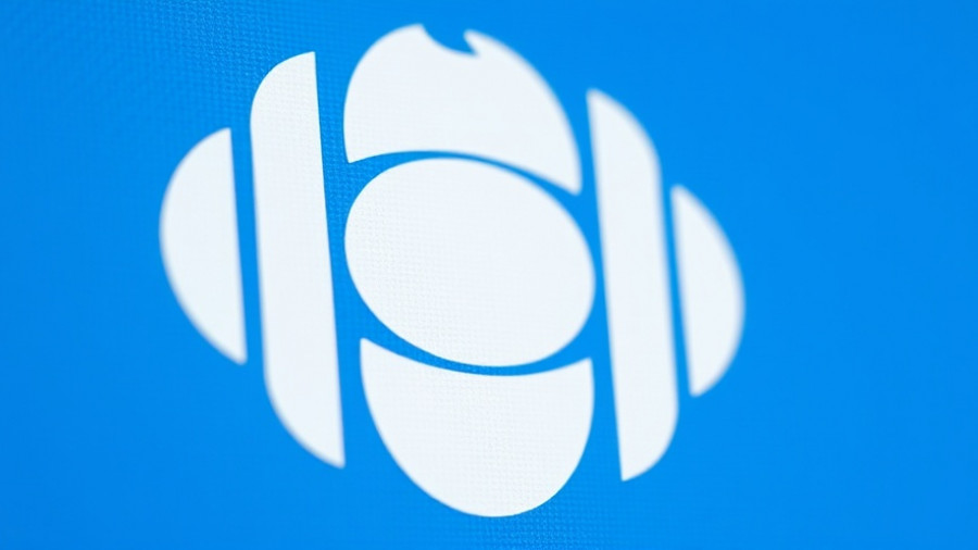 CBC logo close-up on blue background, media branding.