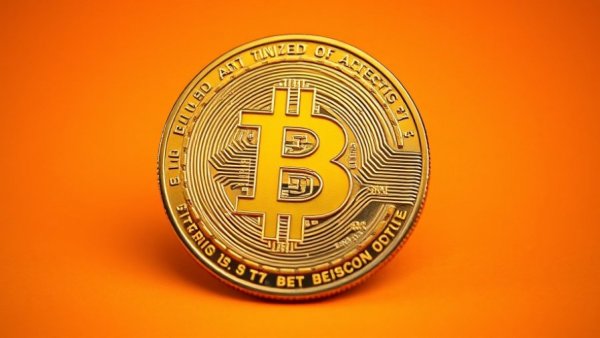 Bitcoin coin on orange background, symbolizing digital currency and Q4 positivity.