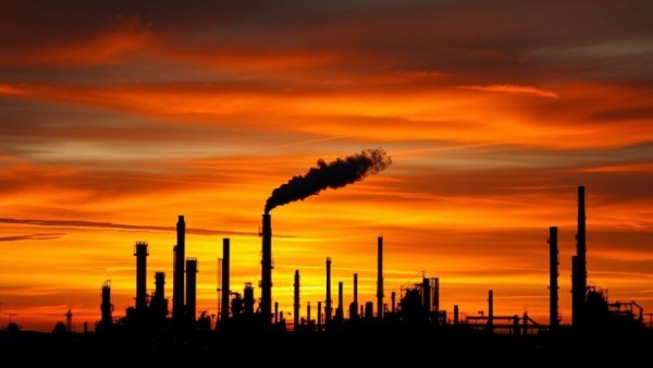 Just Transition Away from Fossil Fuels: Industrial refinery at sunset.
