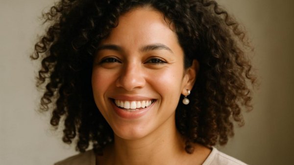 Smiling woman with curly hair and pearl earring, Santa Fe Playhouse leadership changes.