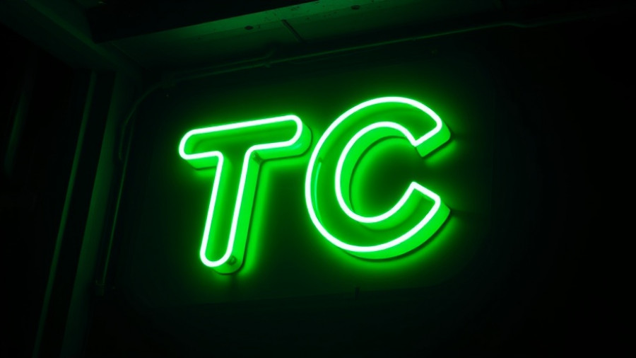 Bright neon TC sign highlighting digital aesthetic.