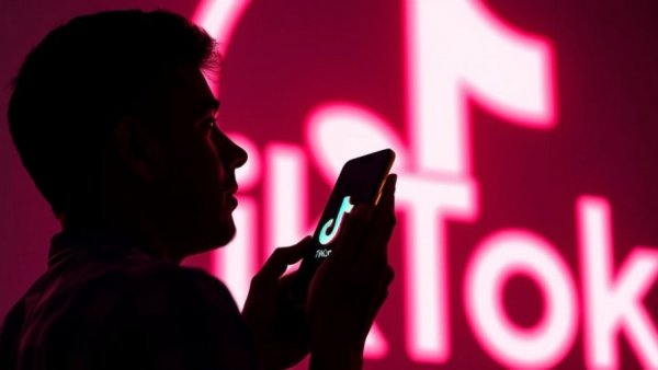 Silhouette with phone displaying TikTok logo, focus on mindfulness badges.