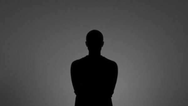 AI society impact symbolized by anonymous silhouette.