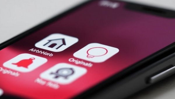 Close-up of smartphone UI showing app icons and search bar for AI technology trends.