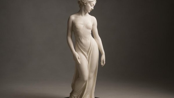 Mylene Costa Exhibit elegant white woman sculpture on black base.
