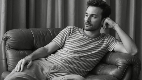 Jamie Miller Babydoll song: man lounging on leather couch, black-and-white photo.