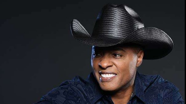 Stylish man in cowboy hat and blue suit, Nashville live music vibe