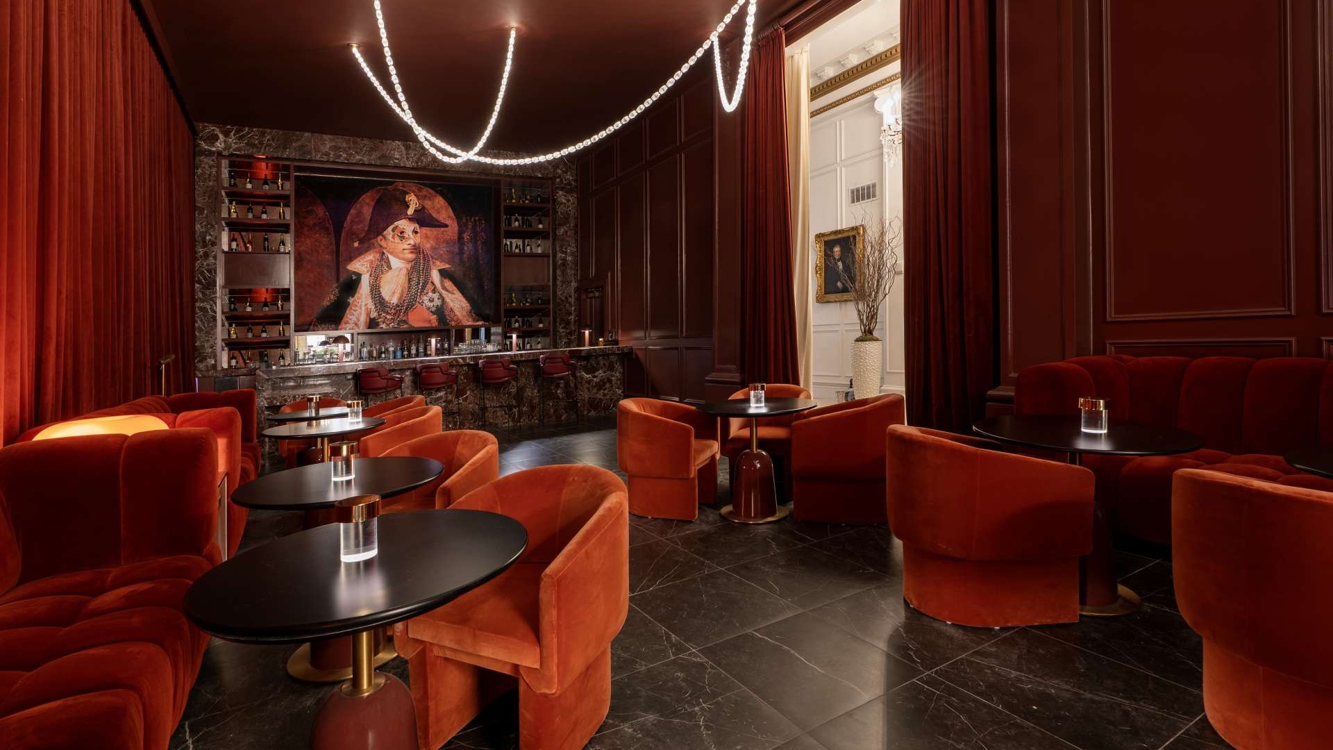 Luxurious New Orleans happy hour Bar 1803 interior with red decor