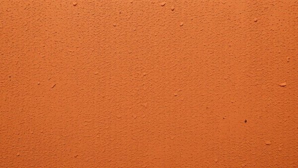 Close-up of inexpensive textured walls with terracotta finish.