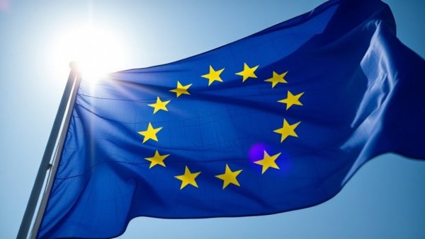 European Union flag under sunlight with blue sky backdrop, relevant to European Commission Tax Omnibus Proposal