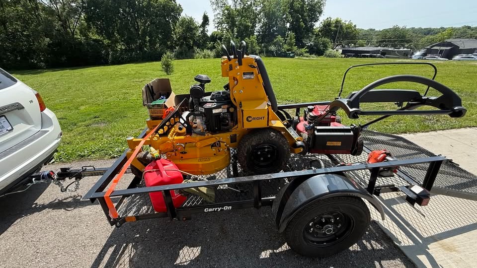 lawn care vehicle, polished expression, parked on freshly cut grass, photorealistic, city park with benches and trees, highly detailed, morning dew on surfaces, exact clarity, cool palette, dappled sunlight, shot with a telephoto lens.