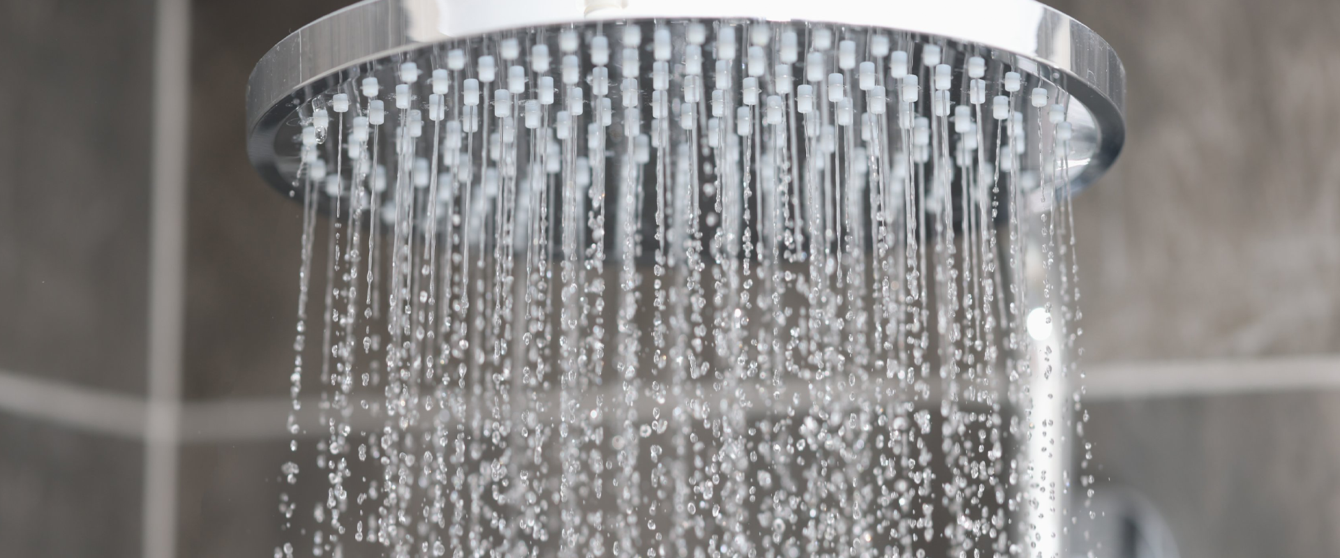 grandiose Lindyspring shower, architectural marvel, water arching high, photorealistic, bustling plaza environment, highly detailed, misty spray, ISO 600, f/11, bronze and cobalt hues, twilight golden hour, shot with a wide-angle lens.