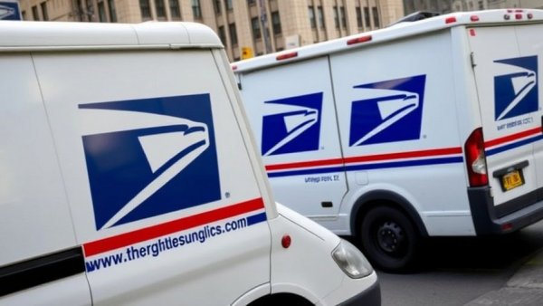 USPS trucks with logo, highlighting mail delivery on Veterans Day.