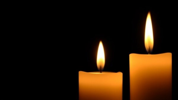 Two glowing candles symbolizing Donyelle Jones's cancer battle journey.