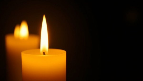Glowing candles in darkness conveying a serene atmosphere.
