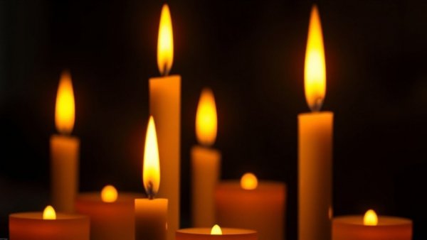 Warm candlelight symbolizing Wai Ching Ho impact on film.