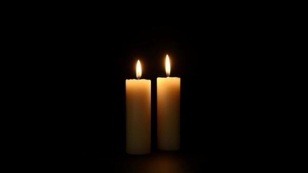 Softly glowing candles symbolizing remembrance.