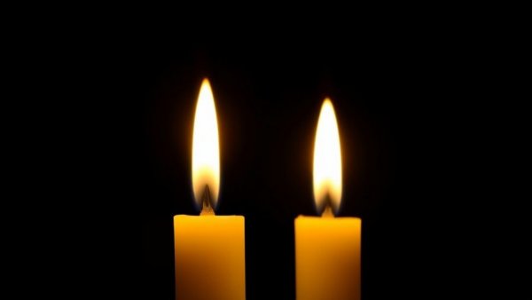 Lit candles in darkness, symbolizing Bunny Levine obituary