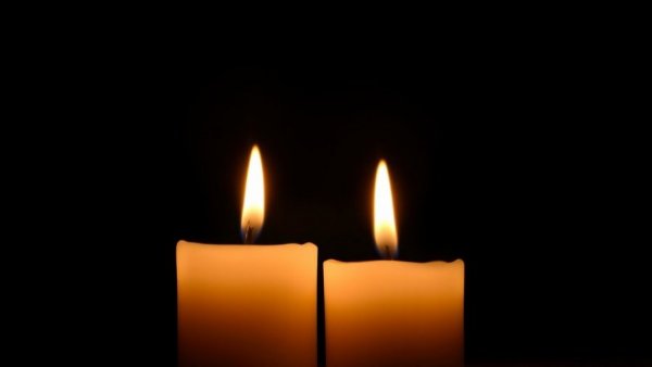 Candles flickering in darkness for Michael Gray Shazam actor memorial.