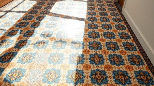 Mosaic tile design with geometric shapes and light shadows.