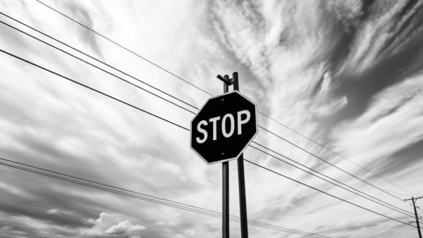Stop sign under cloudy sky representing F&I trends in automotive industry.
