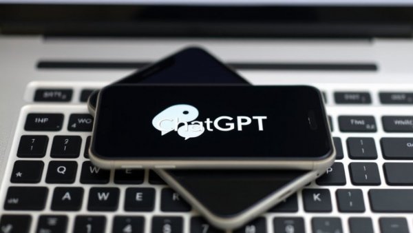 Smartphone with ChatGPT logo on laptop keyboard, symbolizing ChatGPT health emergency response accuracy.