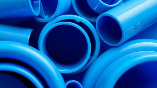 Close-up of custom plastic tubing for fluid management in vibrant blue.