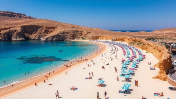 Picturesque beach in Spain with clear turquoise waters and sunbathers.