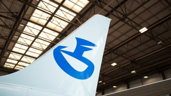 Vibrant blue airplane tail fin logo in industrial hangar.
