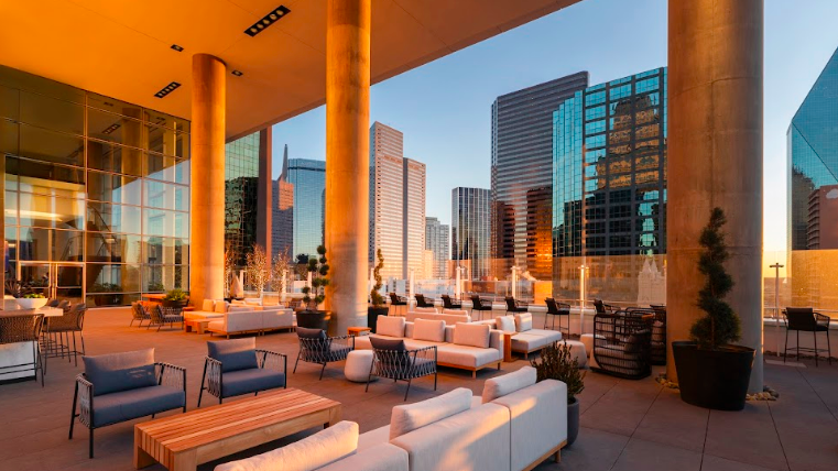 Modern hotel bar in Dallas with sleek design and cityscape view.