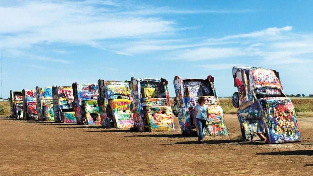 Vibrant graffiti on metal structure, clear sky backdrop.