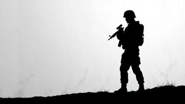 Silhouette of a soldier with rifle, minimalistic background.