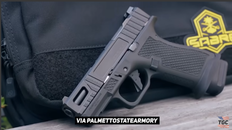 Enthusiastic young adult holding a new firearm in soft lighting, showcasing budget firearms.